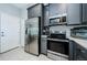 Modern kitchen with stainless steel appliances and gray cabinets at 1621 Eagle Creek Dr, Clearwater, FL 33764