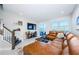 Spacious living room featuring a brown leather sectional sofa at 1621 Eagle Creek Dr, Clearwater, FL 33764