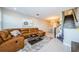 Living room boasts a brown leather sectional and access to patio at 1621 Eagle Creek Dr, Clearwater, FL 33764