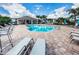 Community pool with lounge chairs and a covered patio at 1621 Eagle Creek Dr, Clearwater, FL 33764