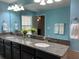 Double vanity bathroom with granite countertops and a large mirror at 17241 Old Tobacco Rd, Lutz, FL 33558