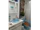 Updated bathroom with light blue vanity and bathtub at 2003 Greenbriar Blvd # 11, Clearwater, FL 33763