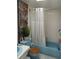 Light blue bathroom with shower/tub combo and white tile at 2003 Greenbriar Blvd # 11, Clearwater, FL 33763