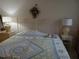 Bedroom with white metal bed frame and a patterned quilt at 2003 Greenbriar Blvd # 11, Clearwater, FL 33763