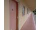Clean condo hallway with light pink doors at 2003 Greenbriar Blvd # 11, Clearwater, FL 33763
