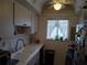 Cozy kitchen with a window, sink, and overhead cabinets at 2003 Greenbriar Blvd # 11, Clearwater, FL 33763