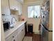 Efficient kitchen with white cabinets and appliances at 2003 Greenbriar Blvd # 11, Clearwater, FL 33763