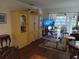 Living room with entertainment center, TV, and access to a balcony at 2003 Greenbriar Blvd # 11, Clearwater, FL 33763