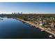 Wide aerial showcasing a waterfront house, neighborhood, and city skyline at 2834 Coffee Pot Ne Blvd, St Petersburg, FL 33704