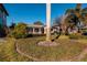 Landscaped front yard with palm tree and walkway leading to house at 2834 Coffee Pot Ne Blvd, St Petersburg, FL 33704