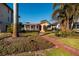 House with manicured lawn, palm trees, and brick walkway at 2834 Coffee Pot Ne Blvd, St Petersburg, FL 33704