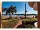Brick walkway leads to waterfront view with palm trees and boats at 2834 Coffee Pot Ne Blvd, St Petersburg, FL 33704