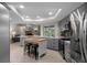 Modern kitchen with gray cabinets, quartz countertops, and kitchen island at 3259 Glenridge Dr, Palm Harbor, FL 34685