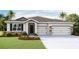 Two-story home with a two-car garage and stone accents at 3418 Hazel Hollow Way, Plant City, FL 33565