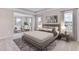 Bright bedroom featuring a king-size bed, sitting area, and large windows at 3546 Thistle Bank Ct, Plant City, FL 33565