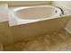 Clean bathroom with an oval bathtub and tiled floor at 4293 Shrimp Ln, North Port, FL 34286