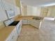 White kitchen cabinets, tile floor, and breakfast bar at 4293 Shrimp Ln, North Port, FL 34286