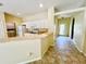 Kitchen with white cabinets, breakfast bar and access to laundry at 4293 Shrimp Ln, North Port, FL 34286