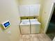 Bright laundry room, washer, dryer, and upper cabinets at 4293 Shrimp Ln, North Port, FL 34286