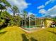 Screened-in pool with lush green backyard at 4293 Shrimp Ln, North Port, FL 34286