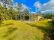 Screened-in pool with lush green backyard at 4293 Shrimp Ln, North Port, FL 34286