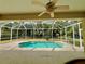 Relaxing screened pool and patio with view of tropical landscape at 4293 Shrimp Ln, North Port, FL 34286