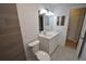 Bathroom with updated vanity and wood-look tile at 619 Glenoak N St, St Petersburg, FL 33703