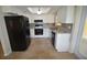 Kitchen features white cabinets, granite counters, and black appliances at 619 Glenoak N St, St Petersburg, FL 33703