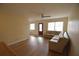 Bright living room featuring hardwood floors and a comfy corner sofa at 619 Glenoak N St, St Petersburg, FL 33703