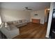 Living room with L-shaped sofa and wood-look floors at 619 Glenoak N St, St Petersburg, FL 33703