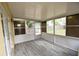 Bright screened porch with wood-look flooring at 619 Glenoak N St, St Petersburg, FL 33703