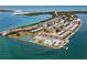 Aerial view of waterfront community with tennis courts and pool at 7 Elgin Pl # 208, Dunedin, FL 34698