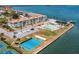 Aerial view of waterfront community with pool, tennis, and shuffleboard at 7 Elgin Pl # 208, Dunedin, FL 34698