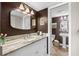 Bathroom with granite countertop, white cabinets, and walk-in shower at 7 Elgin Pl # 208, Dunedin, FL 34698