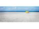 Beach with a yellow shade structure at 7 Elgin Pl # 208, Dunedin, FL 34698