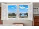 Bedroom with water views from open shutters at 7 Elgin Pl # 208, Dunedin, FL 34698