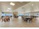 Bright community room with tables, chairs, and a fireplace at 7 Elgin Pl # 208, Dunedin, FL 34698
