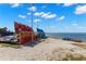 Colorful kayaks are lined up on the beach near the water at 7 Elgin Pl # 208, Dunedin, FL 34698