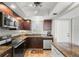 Modern condo kitchen featuring stainless steel appliances and granite countertops at 7 Elgin Pl # 208, Dunedin, FL 34698