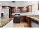 Bright condo kitchen with stainless steel appliances and granite countertops at 7 Elgin Pl # 208, Dunedin, FL 34698