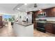 Updated condo kitchen with granite island, stainless steel appliances, and wood cabinets at 7 Elgin Pl # 208, Dunedin, FL 34698