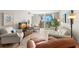 Condo living room showcasing comfortable leather furniture and a balcony at 7 Elgin Pl # 208, Dunedin, FL 34698