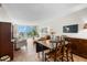 Condo living room with comfortable seating and access to a balcony with water views at 7 Elgin Pl # 208, Dunedin, FL 34698