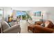 Bright and airy condo living room featuring comfy seating and water views at 7 Elgin Pl # 208, Dunedin, FL 34698