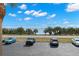 View of parking lot with water view beyond at 7 Elgin Pl # 208, Dunedin, FL 34698