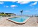 Community swimming pool with lounge chairs and waterfront views at 7 Elgin Pl # 208, Dunedin, FL 34698