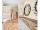 Elegant bathroom boasting double sinks, granite counters, and a walk-in shower at 8731 Betty St, Port Richey, FL 34668