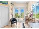 Home office featuring a comfortable chair and access to a balcony at 8731 Betty St, Port Richey, FL 34668