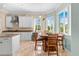 Bright kitchen with granite countertops, white cabinets, and breakfast nook at 8731 Betty St, Port Richey, FL 34668