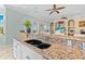 Kitchen with granite countertops, double sink, and white cabinets at 8731 Betty St, Port Richey, FL 34668